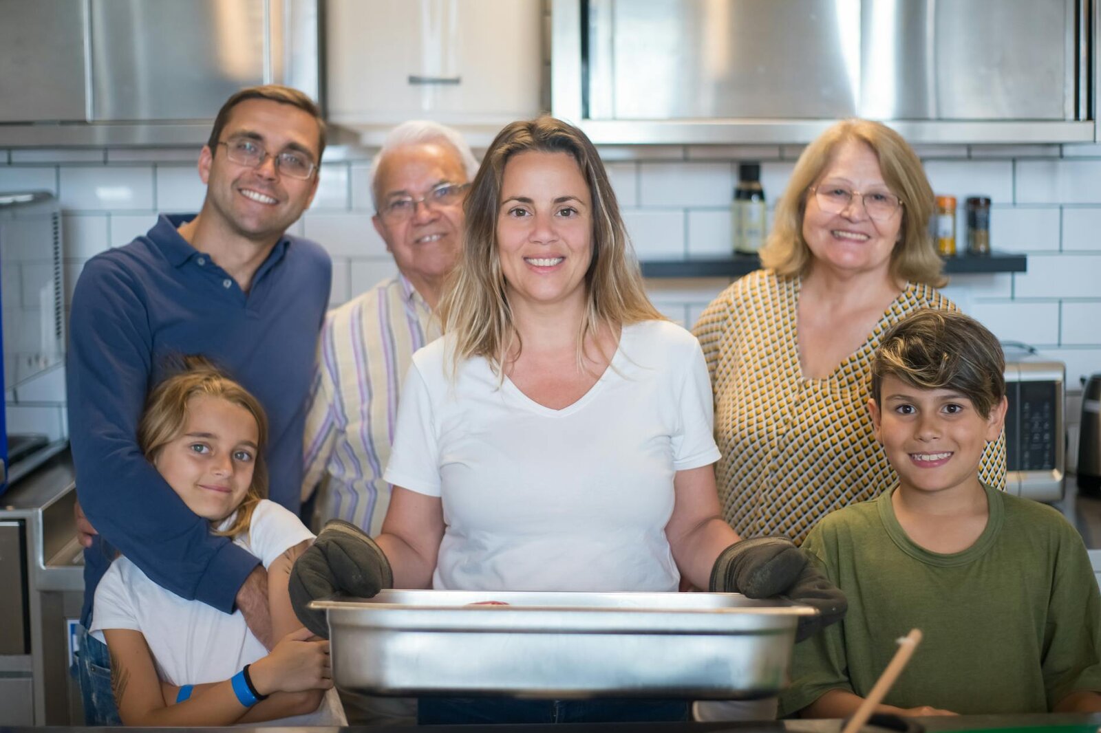 Familia multigeneracional prepara comida junta en una cocina.