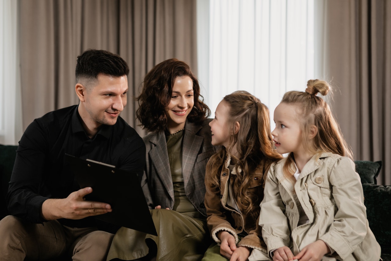A Colorado family at home, looking over paperwork together — the kind of family conversation behind this page’s question: hire a lawyer, hire a Licensed Legal Paraprofessional, or handle a Colorado divorce alone.