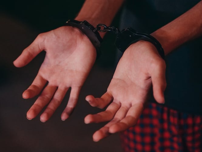 person in handcuffs