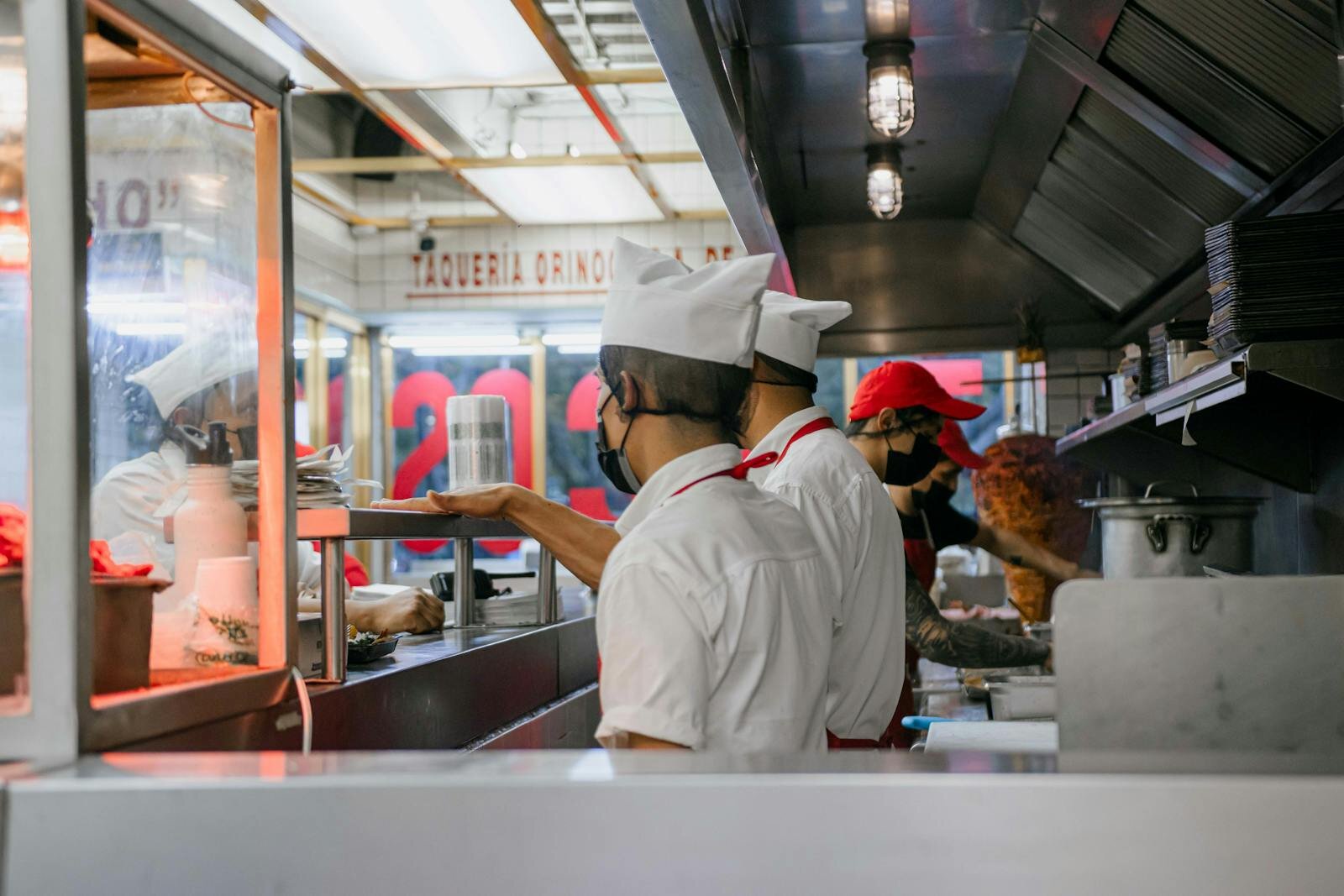Immigrant workers in a taquería kitchen — protections under federal and Colorado law reach workers regardless of immigration status.