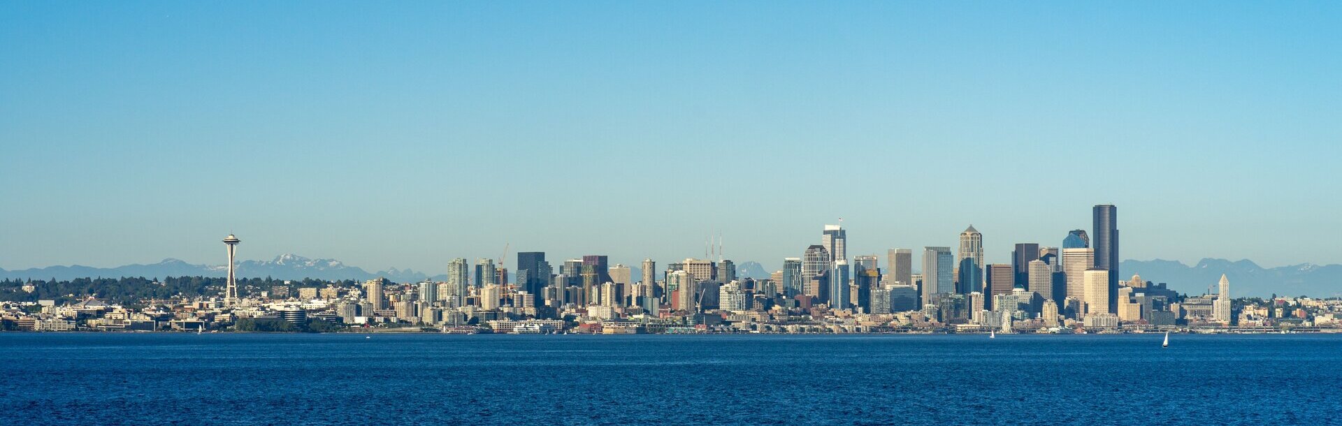 Seattle skyline across Elliott Bay under a calm sky