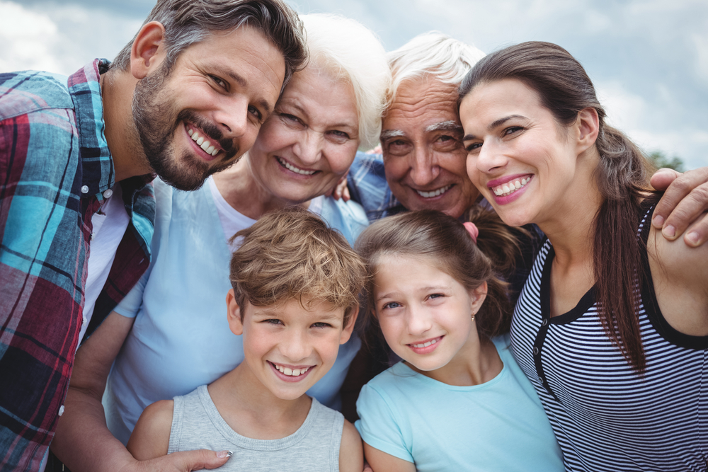 Portrait of happy multi-generation family standing outdoors